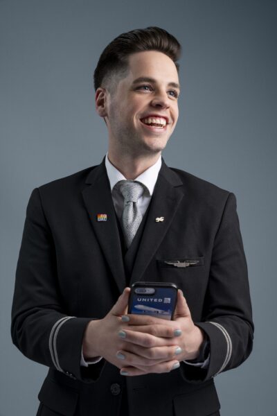 Flight attendant wearing metallic gray nail polish and natural-looking makeup.