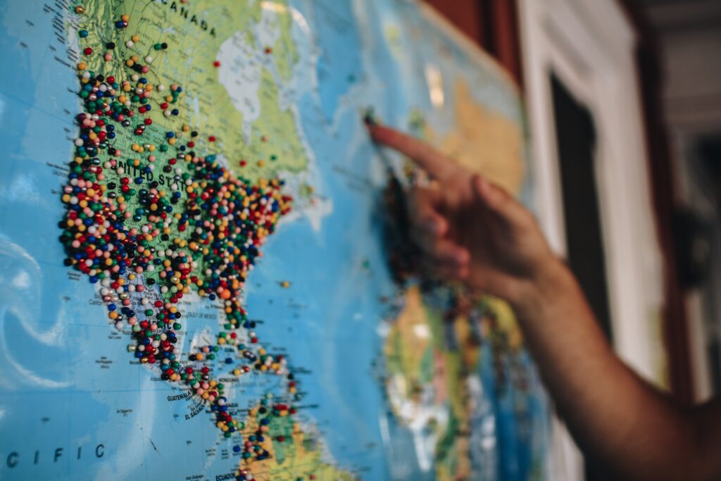 Map of the world with several colored pushpins 
