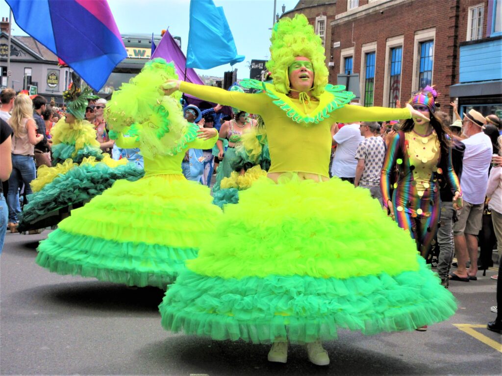 Drag queens twirling in dresses at Brighton Pride