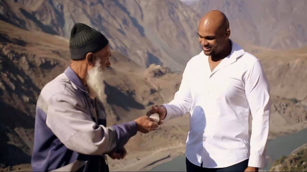 Ernest chatting with a man in Tajikistan.