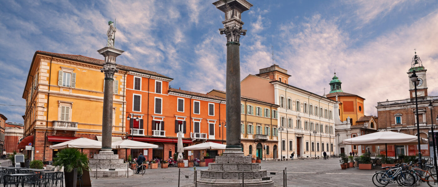 Ravenna, Emilia-Romagna, Italy: the main square Piazza del Popolo with the ancient columns with the statues of Saint Apollinare and Saint Vitale (Photo Credit: iStock)