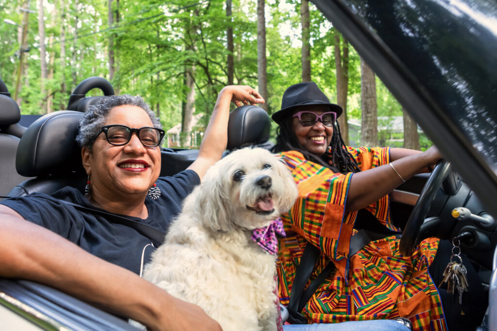LGBT family driving in their convertible (Photo Credit: iStock)