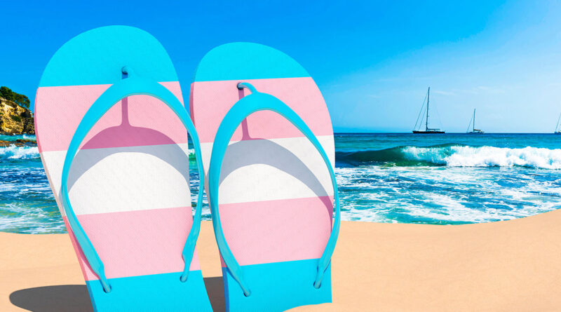 Transgender flag flip flops on a beach (Photo Credit: Shutterstock)