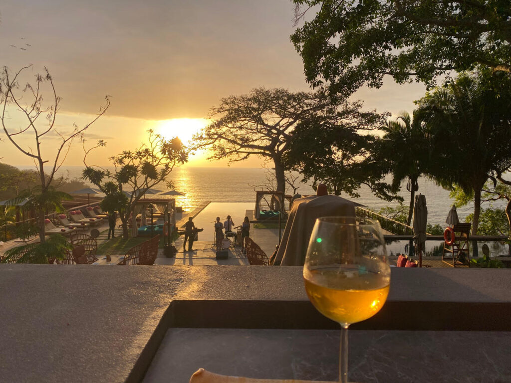 Glass of wine overlooking One&Only Mandarina Deck at Sunset (Photo Credit: Keith Wein)