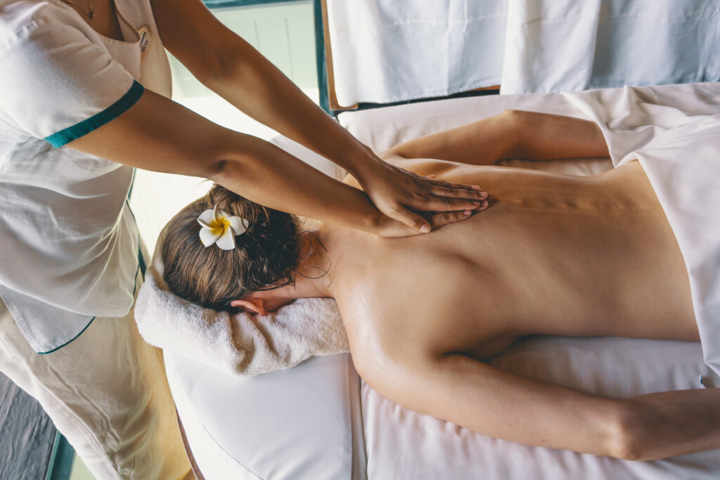 Woman getting a massage at The Sun Spa by the Healing Earth