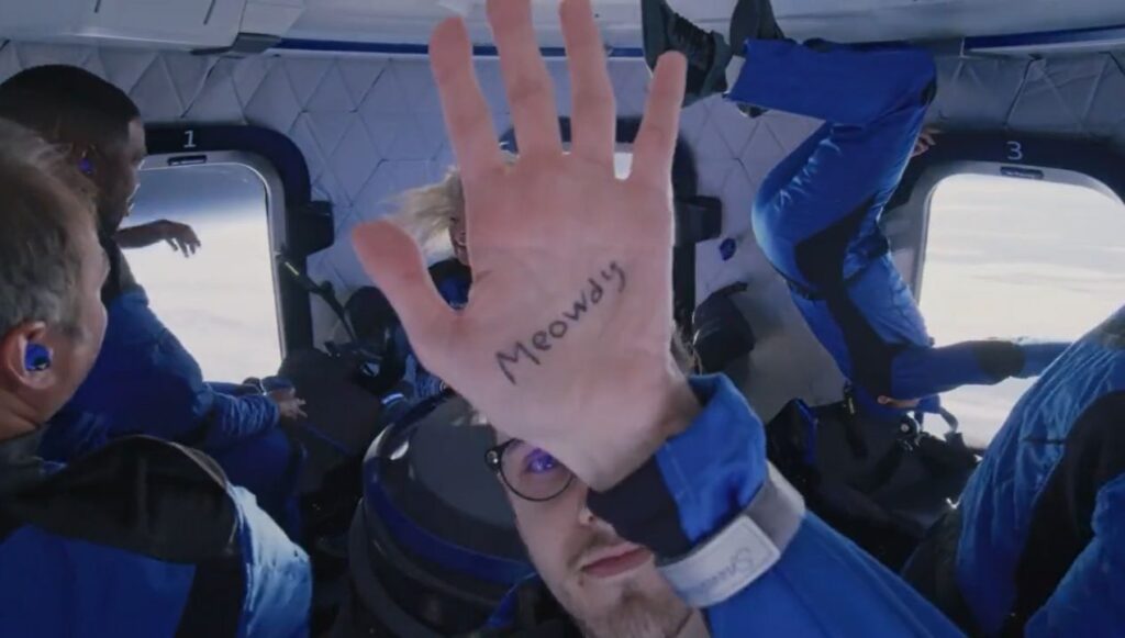 Cameron Bess holds up a "Meowdy" message on Blue Origin New Shepard NS-19. (Photo Credit: Blue Origin)