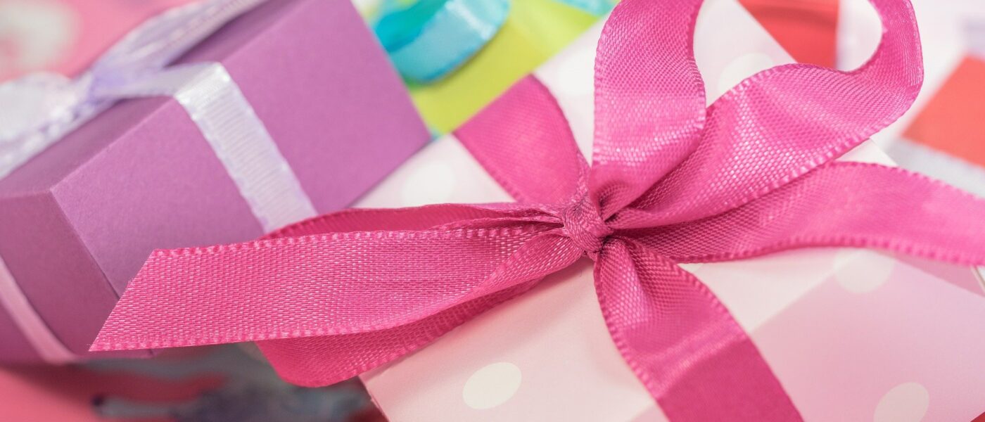 Colorfully wrapped gifts with bows (Photo Credit: Michael Schwarzenberger from Pixabay)