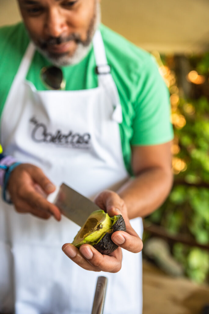 Kwin scooping out avocado to make guacamole at a cooking class at Las Caletas. (Photo Credit: Josh Laskin)