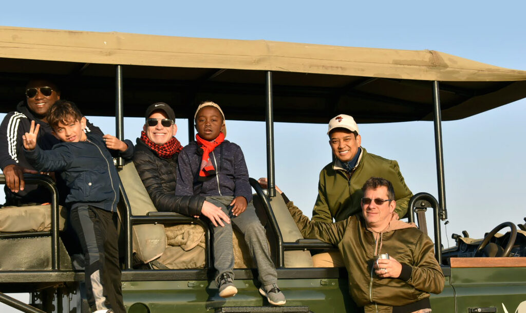 Jeffrey Solomon (front right) and family, friends on a pilot safari for same-sex families. (Photo Credit: African Travel, Inc.)