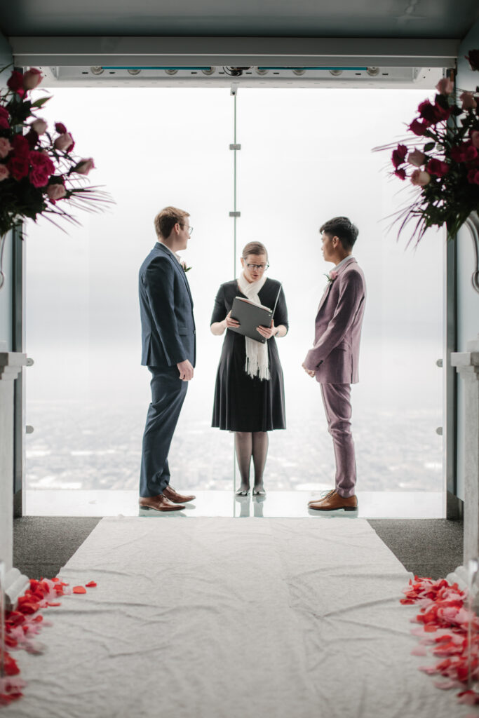 Eric and Carlo's wedding ceremony on the Ledge at Skydeck Chicago. (Photo Credit: Skydeck Chicago)