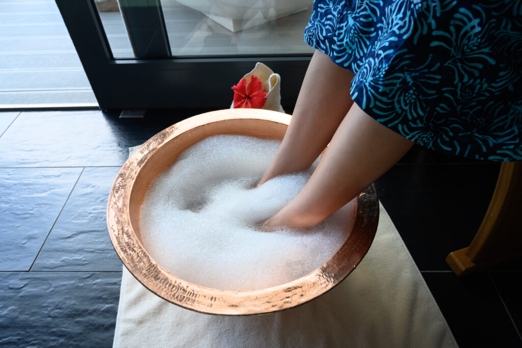 Guest soaking feet at The Sun Spa by Healing Earth 