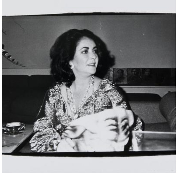 Elizabeth Taylor at a dinner party at Haltons townhouse in NYC. (Courtesy Hedges Projects, Los Angeles. Copyright The Andy Warhol Foundation for the Visual Arts.)