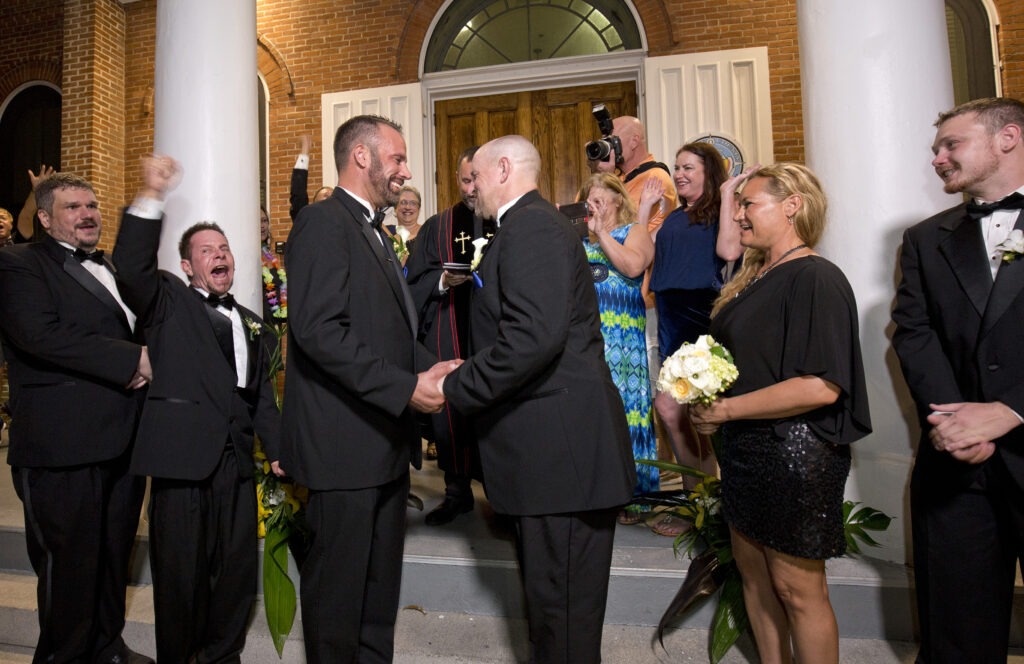 Aaron Huntsman, center left, and William Lee Jones, center right, complete their wedding vows on the steps of the Monroe County Courthouse. (Photo Credit: Rob O'Neal/Florida Keys News Bureau)