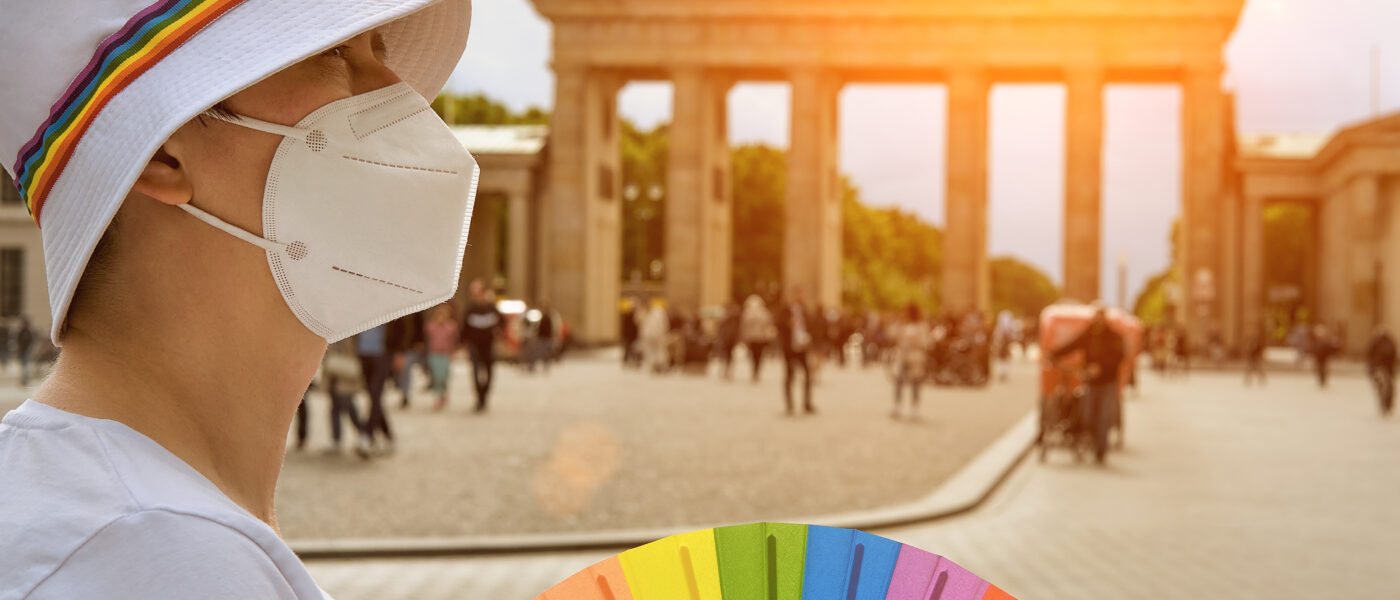 Queer traveler near Brandenburg Gate in Berlin, Germany (Photo Credit: anyaivanova / iStock)