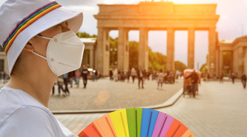 Queer traveler near Brandenburg Gate in Berlin, Germany (Photo Credit: anyaivanova / iStock)