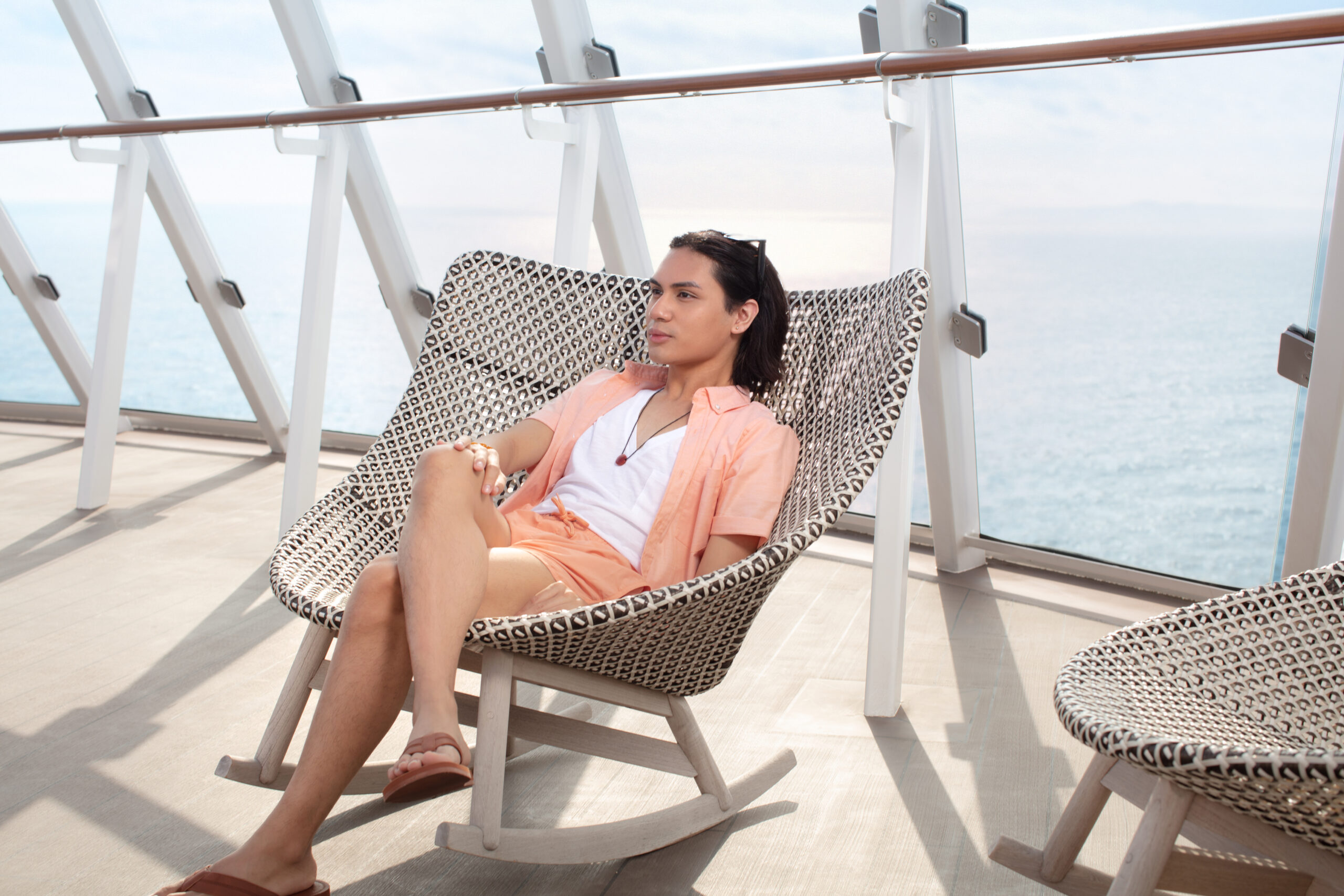 Micah Ramos, a non-binary model, lounges on the Retreat Sundeck on Celebrity Edge. (Photo Credit: Naima Green / Celebrity Cruises / AIPP)