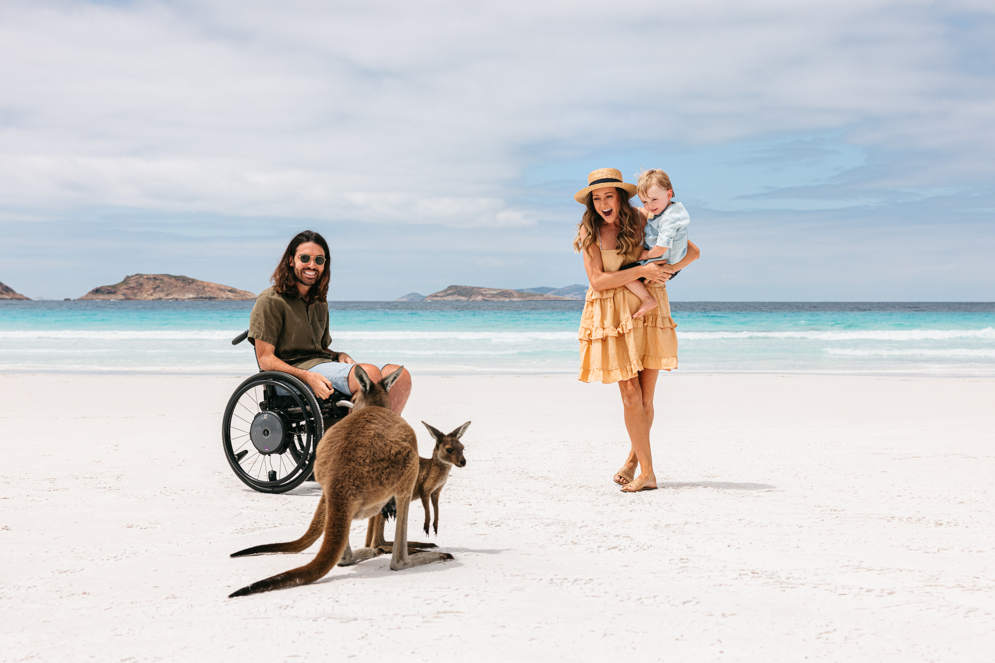 Wildlife photographer Jaimen, his wife Jess, and their child checking out kangeroos on a beach in Austraila. (Photo Credit: Jarrad Seng / Celebrity Cruises / AIPP)