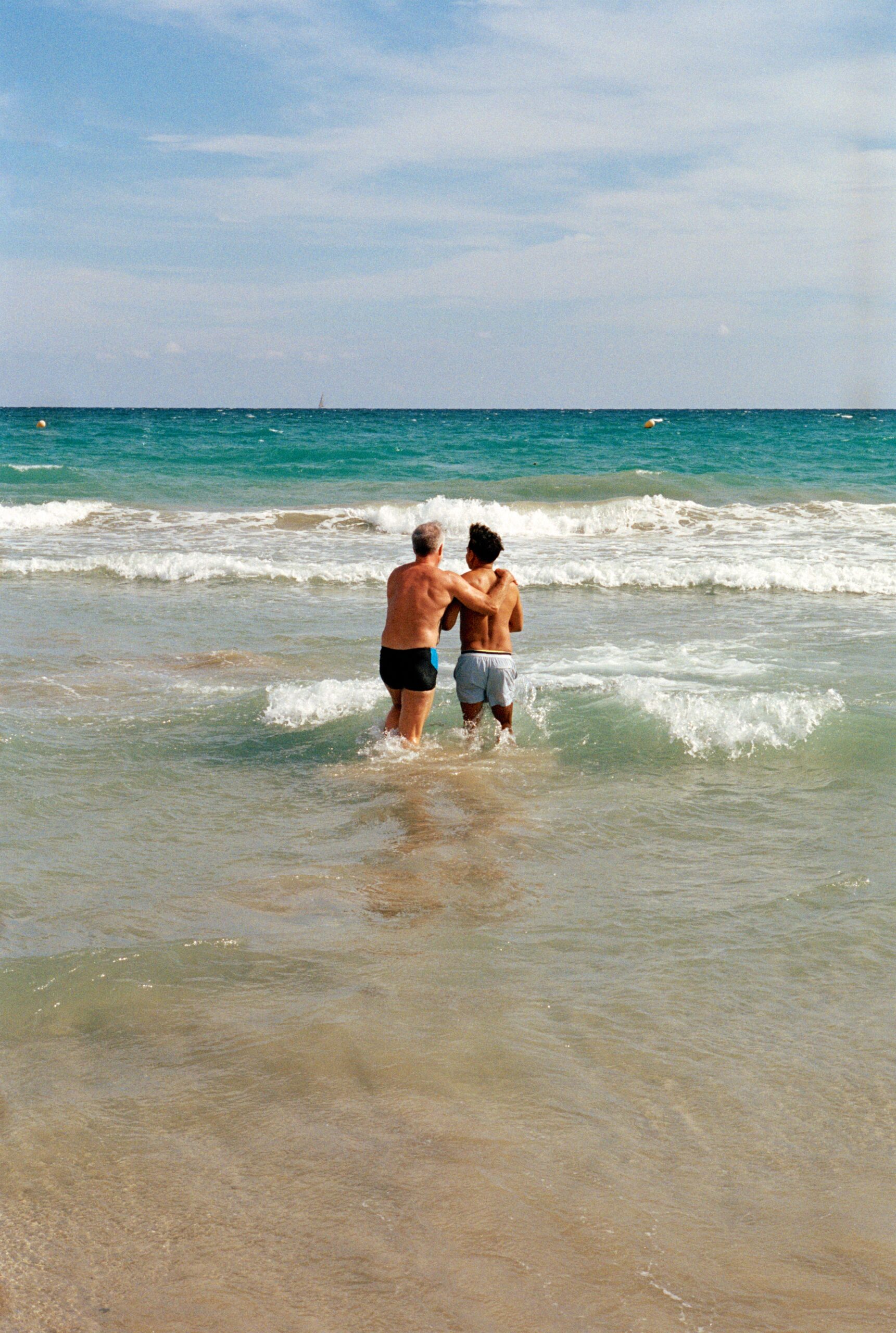 Tim and Sheehan walk into the sea as part of Celebrity Cruises' All-Inclusive Photo Project campaign. (Photo Credit: Giles Duley / Celebrity Cruises / AIPP)