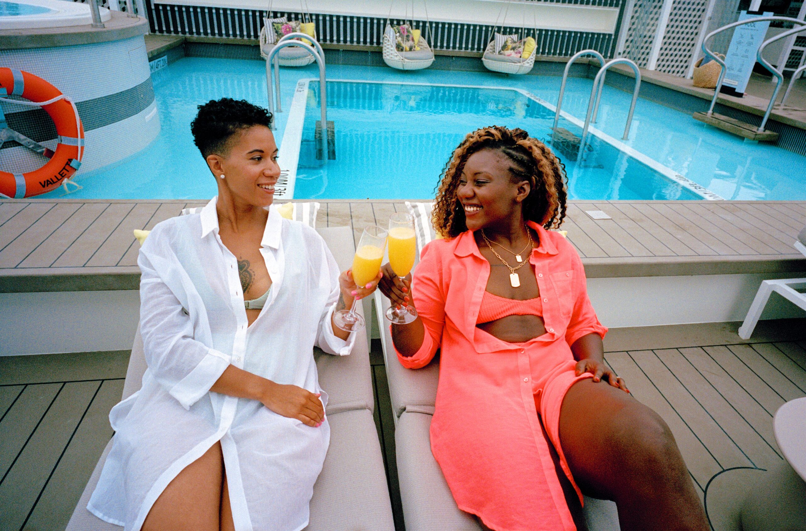 LGBTQ+ activists Aisha and Lexie have a drink by The Retreat sundeck onboard Celebrity Apex. (Photo Credit: Giles Duley / Celebrity Cruises / AIPP)