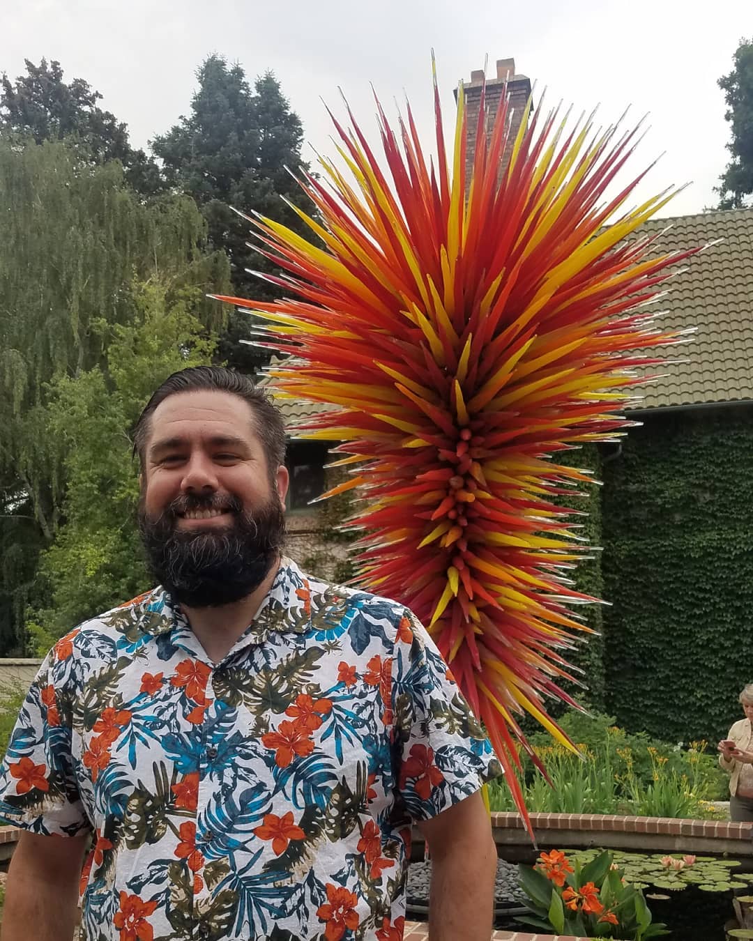 Alex Bryce in front of a Chihuly glass piece at Denver Botanical Gardens in Denver, Colorado.
