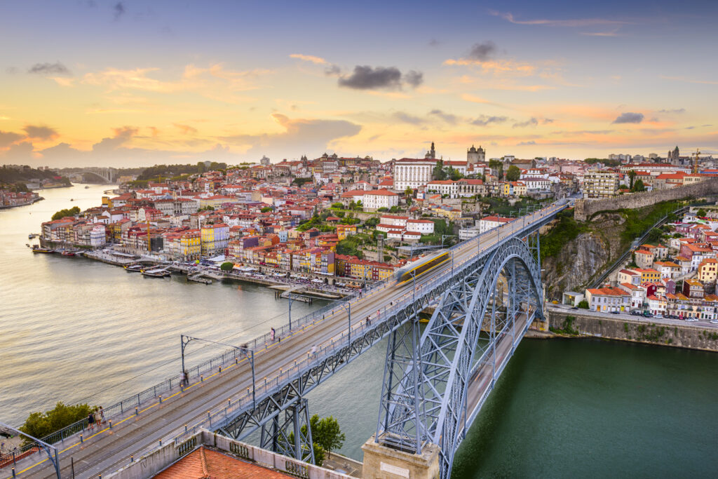 Dom Luis Bridge over the famous Douro River with Porto cityscape (Photo Credit: SeanPavonePhoto / iStock)