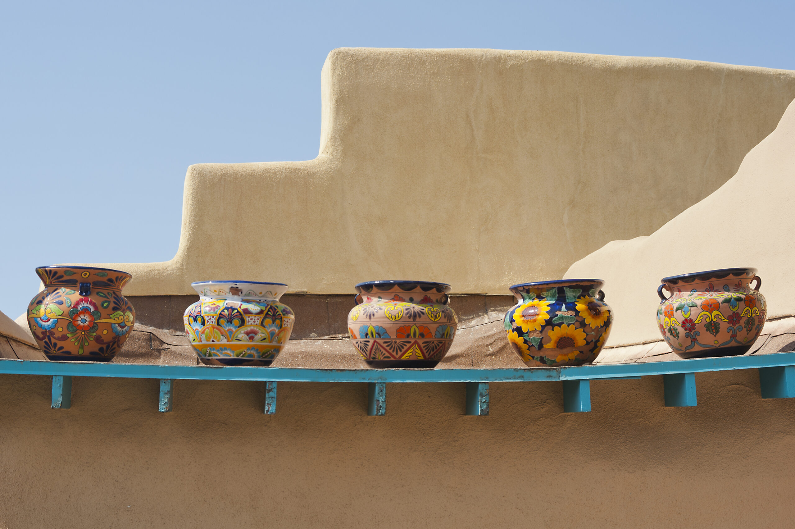 Pottery atop an adobe building in Taos (Photo Credit: chapin31 / iStock)