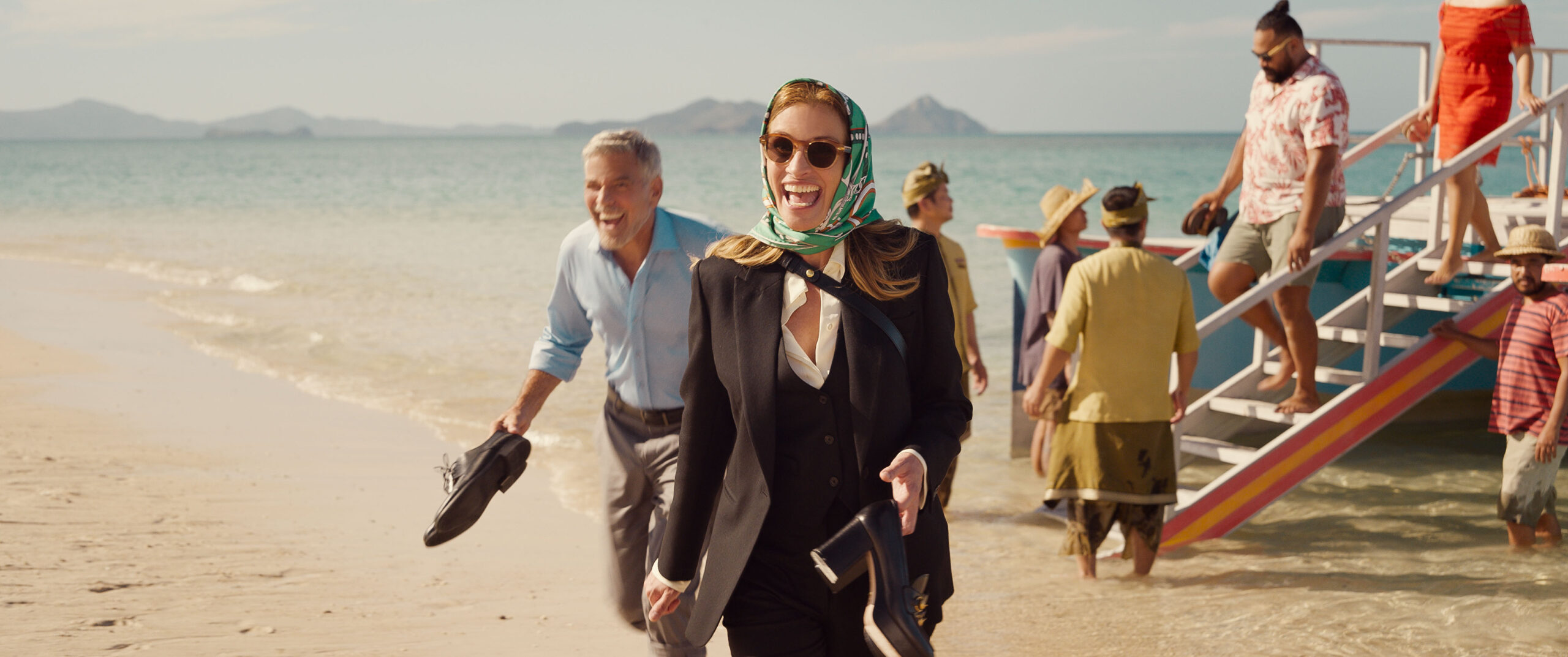 David (George Clooney) and Georgia (Julia Roberts) in the movie "Ticket to Paradise," arriving in "Bali". (Photo Credit: Universal Pictures)