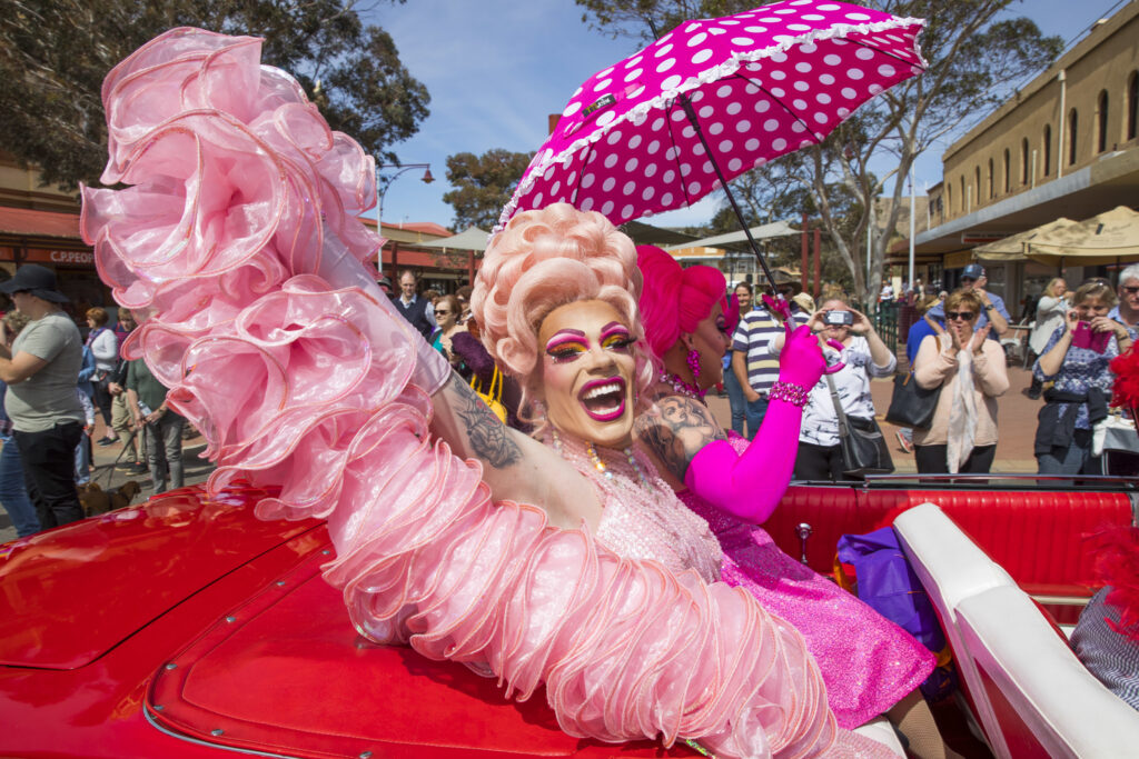 Glamourous hosts Philmah Bocks and Art Simone on Main Street for the Broken Hill Festival in Broken Hill (Photo Credit: Destination NSW)