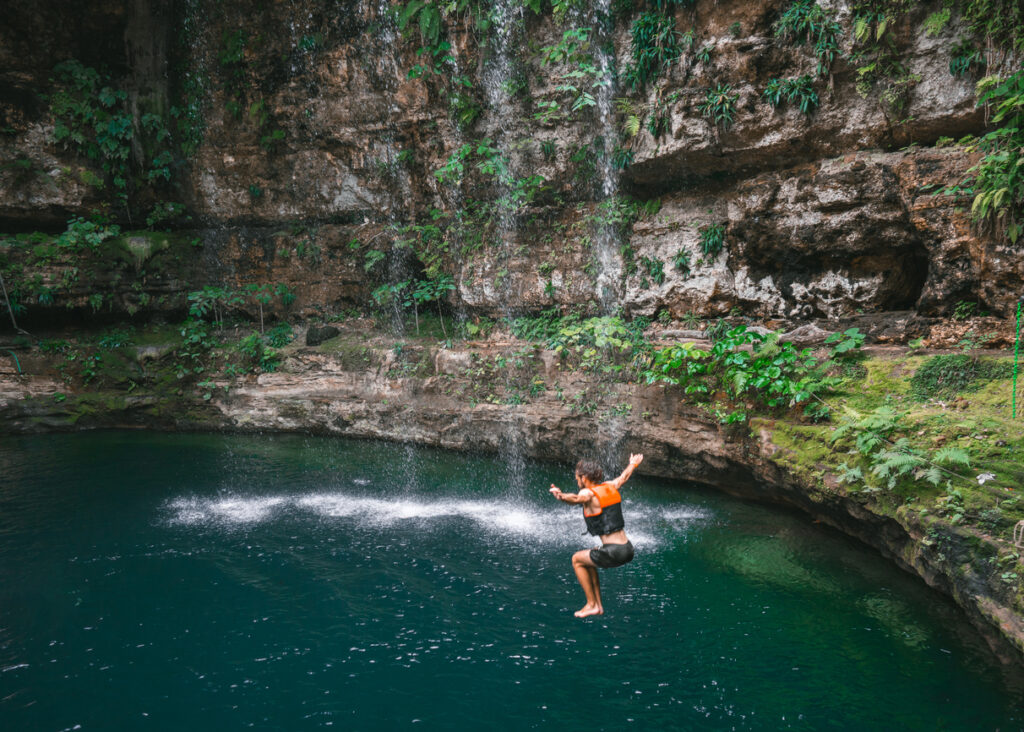 Man jumping into a cenote in Yucatan, Mexico. (Photo Credit: Oleh Slobodeniuk / iStock)