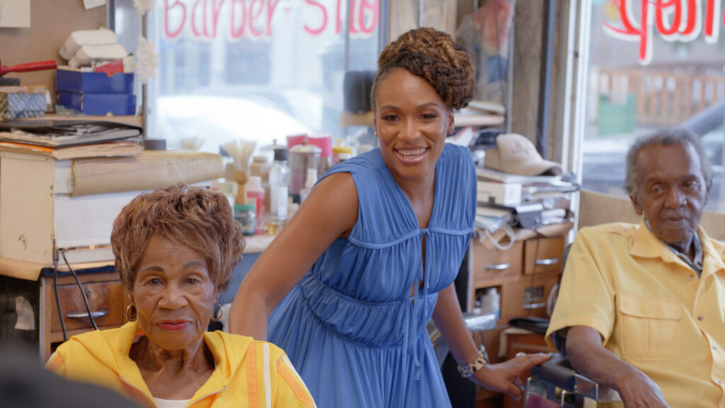 Host Martinique Lewis (Marty) poses for a portrait with Franklin and Maedella Stiger, who have run a barber shop in the Five Points district of Denver, Colo. for over 40 years. (National Geographic for Disney)