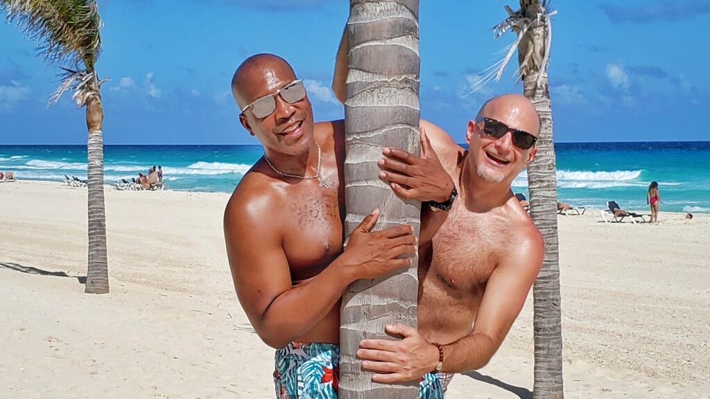 Troy and his husband, Barnett Halston (aka @dcfashionfool) at Breezes Resort Bahamas in Nassau (Photo courtesy of Troy Petenbrink)