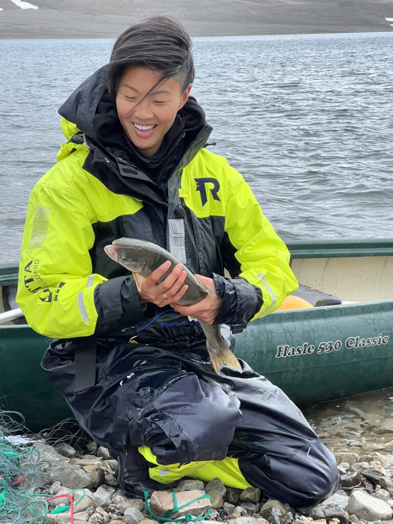 Chef Kristen Kish holds a fish in Svalbard, Norway. (Photo Credit: National Geographic/Missy Bania)