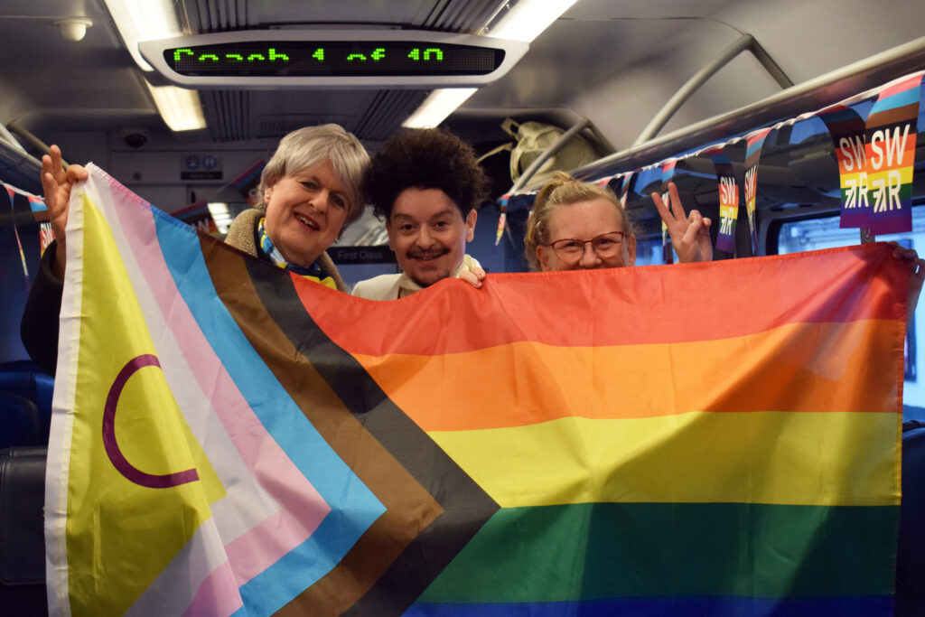 Valentino Vecchietti and SWR Pride Network with flag (Photo Credit: South Western Railway)