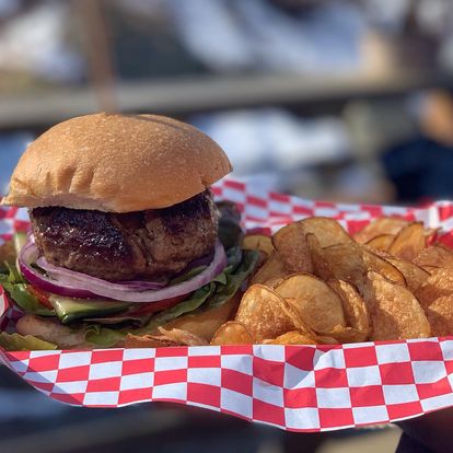 Shipley Farm Burger stuffed with foie gras and truffle butter, dill pickles, red onion, tomato, dijonaise (Photo Credit: The Cardinal)