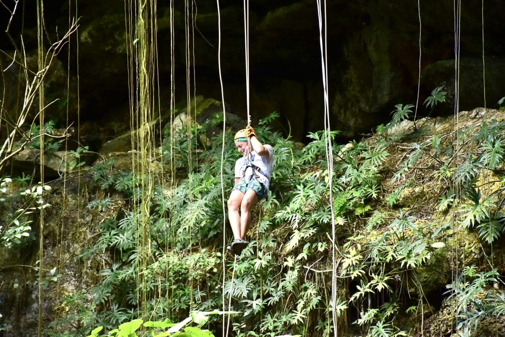 Jon repelling into a cenote near Coba (Photo Credit: Jon Bailey)