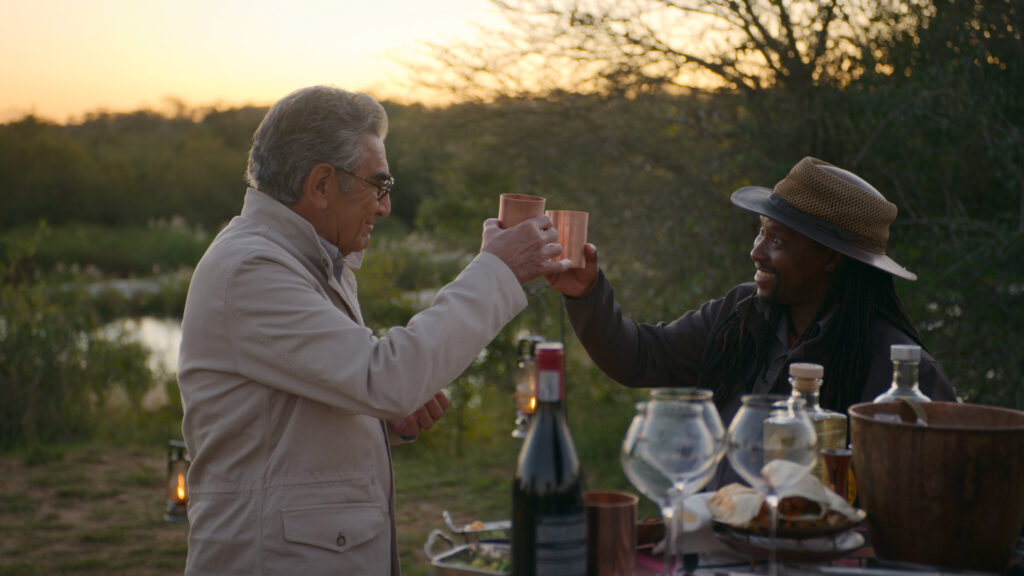 Eugene Levy meets with Bonga Njajula while visiting South Africa. (Photo Credit: The Reluctant Traveler / Apple TV+)