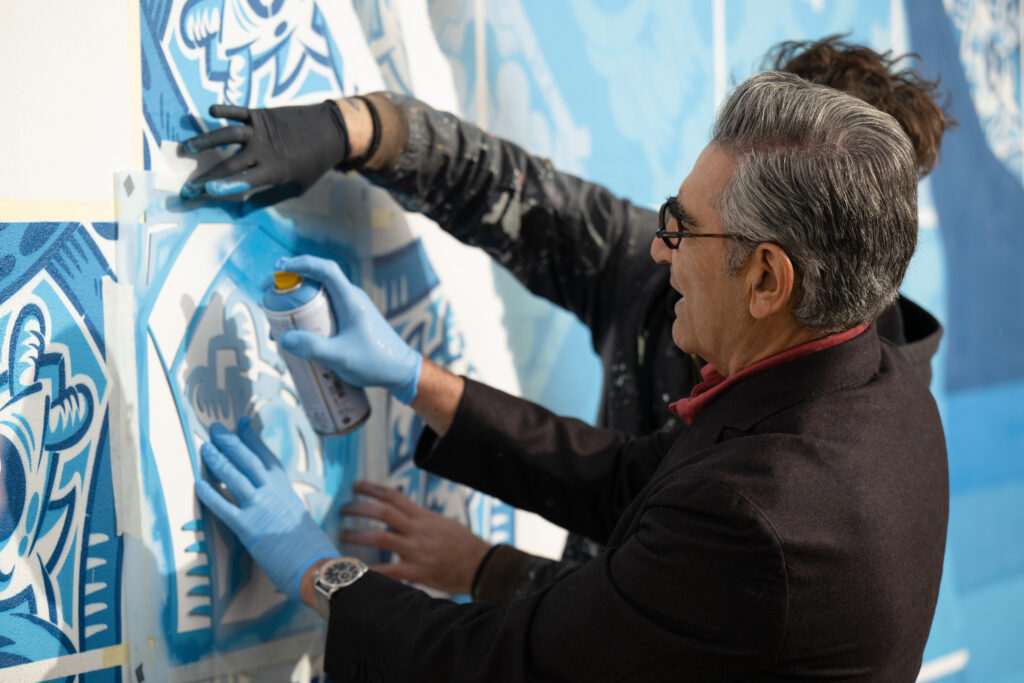 Eugene Levy painting tiles in Lisbon, Portugal. (Photo Credit: The Reluctant Traveler / Apple TV+)