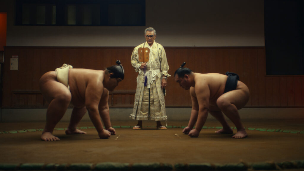 Eugene Levy meets Kensho Sawada and Yoshinori Tashiro while visiting Tokyo. (Photo Credit: The Reluctant Traveler / Apple TV+)