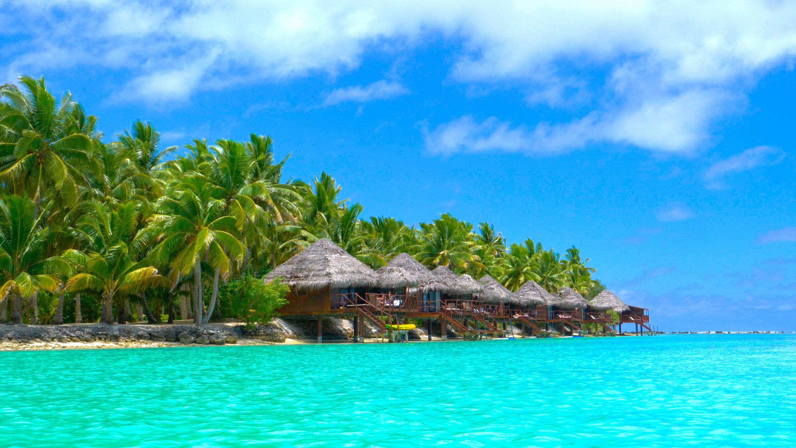 Beautiful luxury overwater villas face the stunning turquoise ocean water in the idyllic Cook Islands. (Photo Credit: Flystock / Shutterstock)