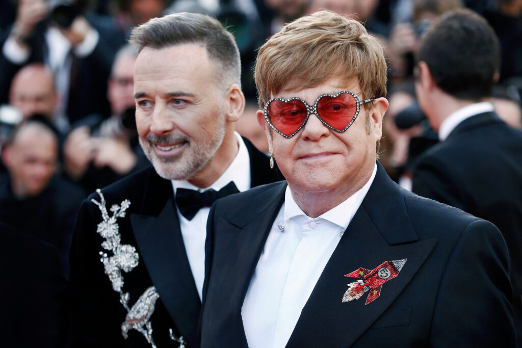 Sir Elton John and his husband David Furnish in Cannes, France (Photo Credit: Andrea Raffin / Shutterstock)
