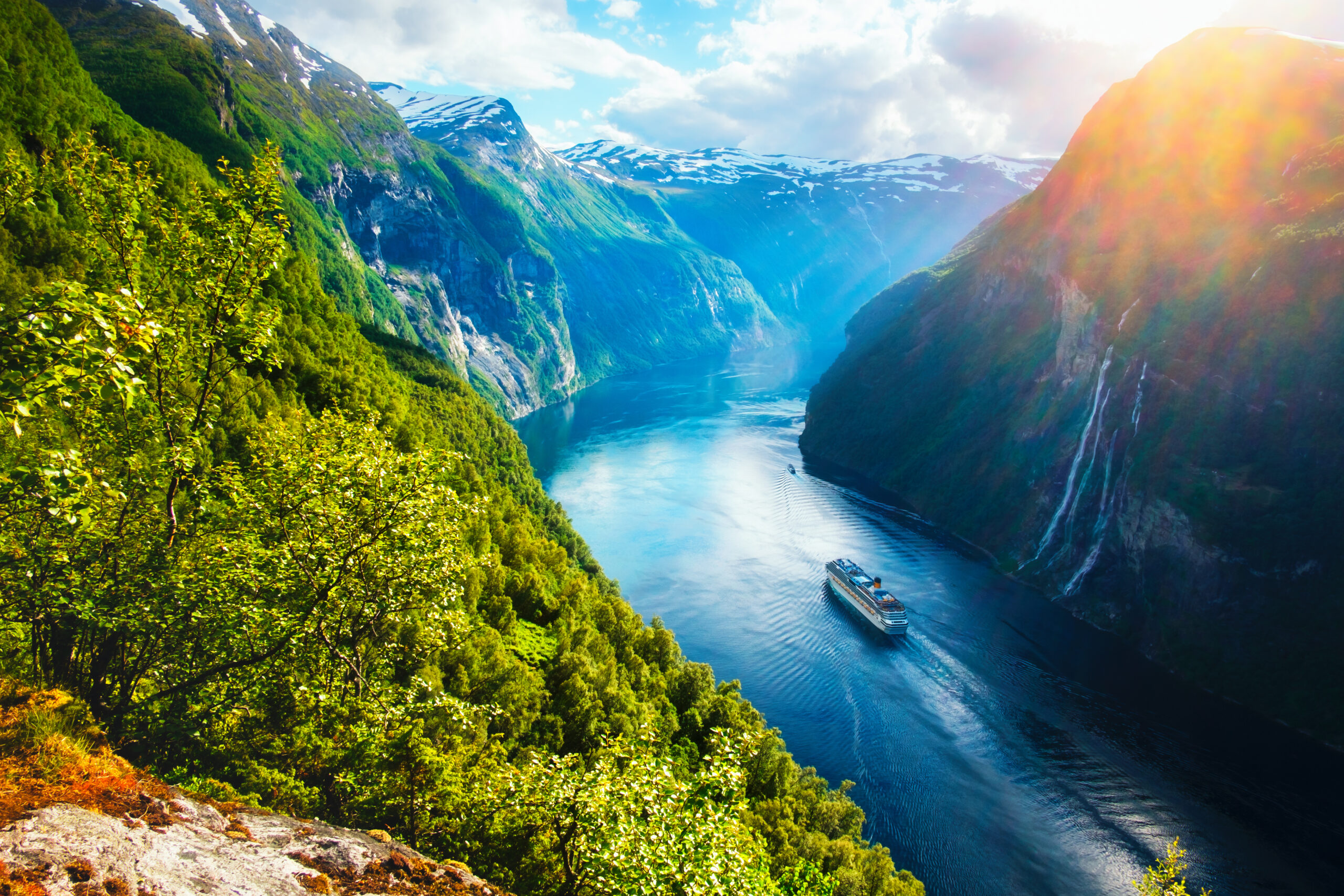 Breathtaking view of the Sunnylvsfjorden fjord with cruise ship and famous Seven Sisters waterfalls in Norway (Photo Credit: Smit / Shutterstock)