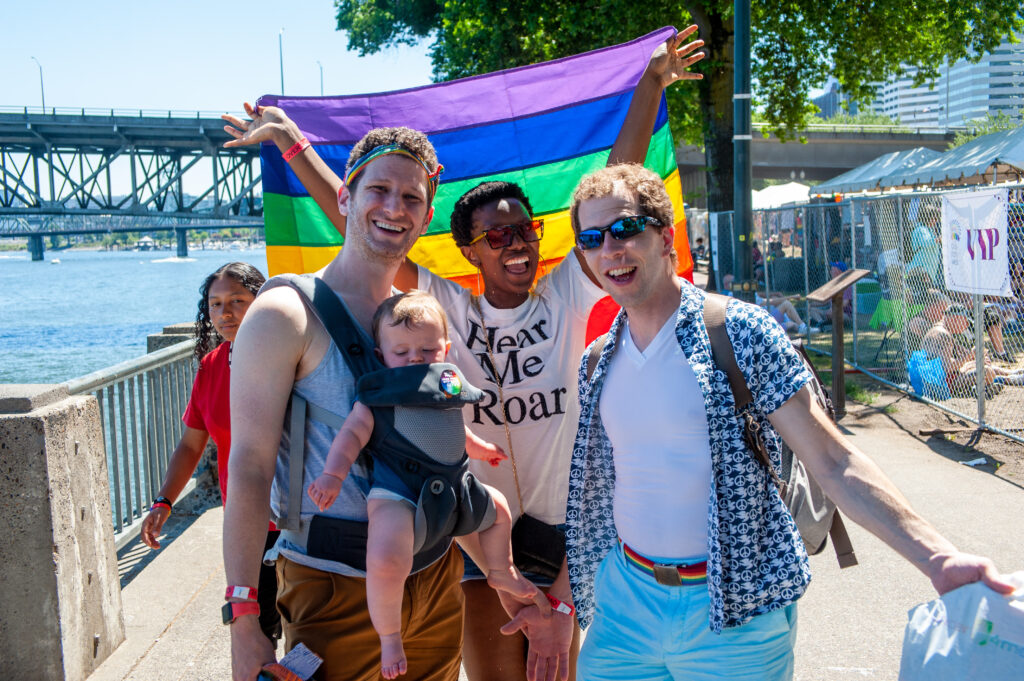 LGBTQ+ family and friend at annual Pride parade in Portland, Oregon (Photo Credit: Diego G Diaz / Shutterstock)