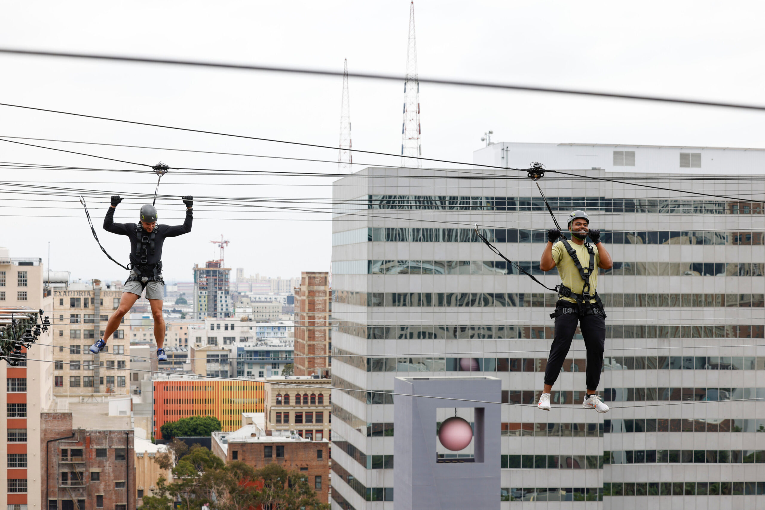 Joe Moskowitz (left) and Greg Franklin traverse a tightrope stretched from one rooftop to another at the historic Biltmore Hotel in downtown LA. (Photo Credit: Sonja Flemming/CBS)