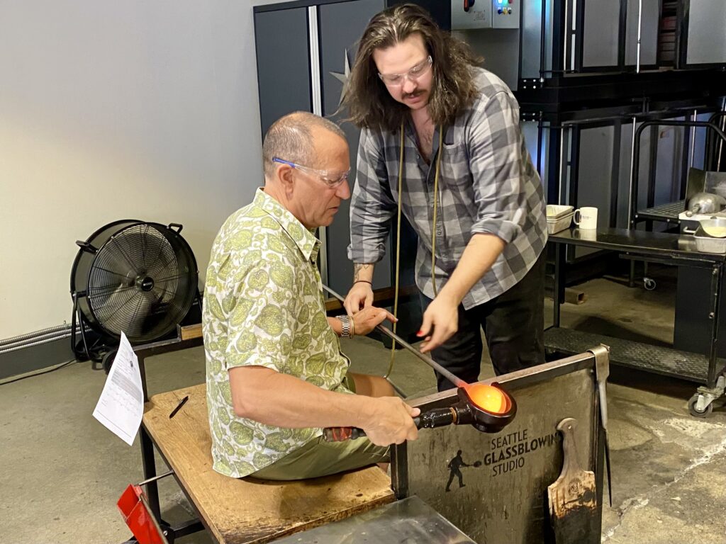 Jon Bailey gets a glass-blowing lesson at the Seattle Glassblowing Studio (Photo Credit: Jon Bailey)