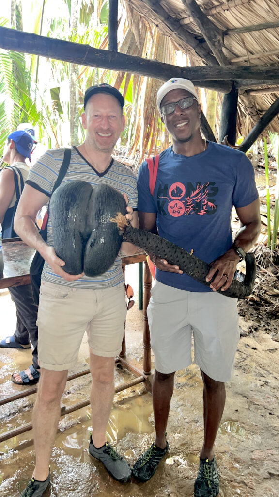 Paul and his husband hold the male and female coco de mer seeds (Photo Credit: Paul J. Heney)