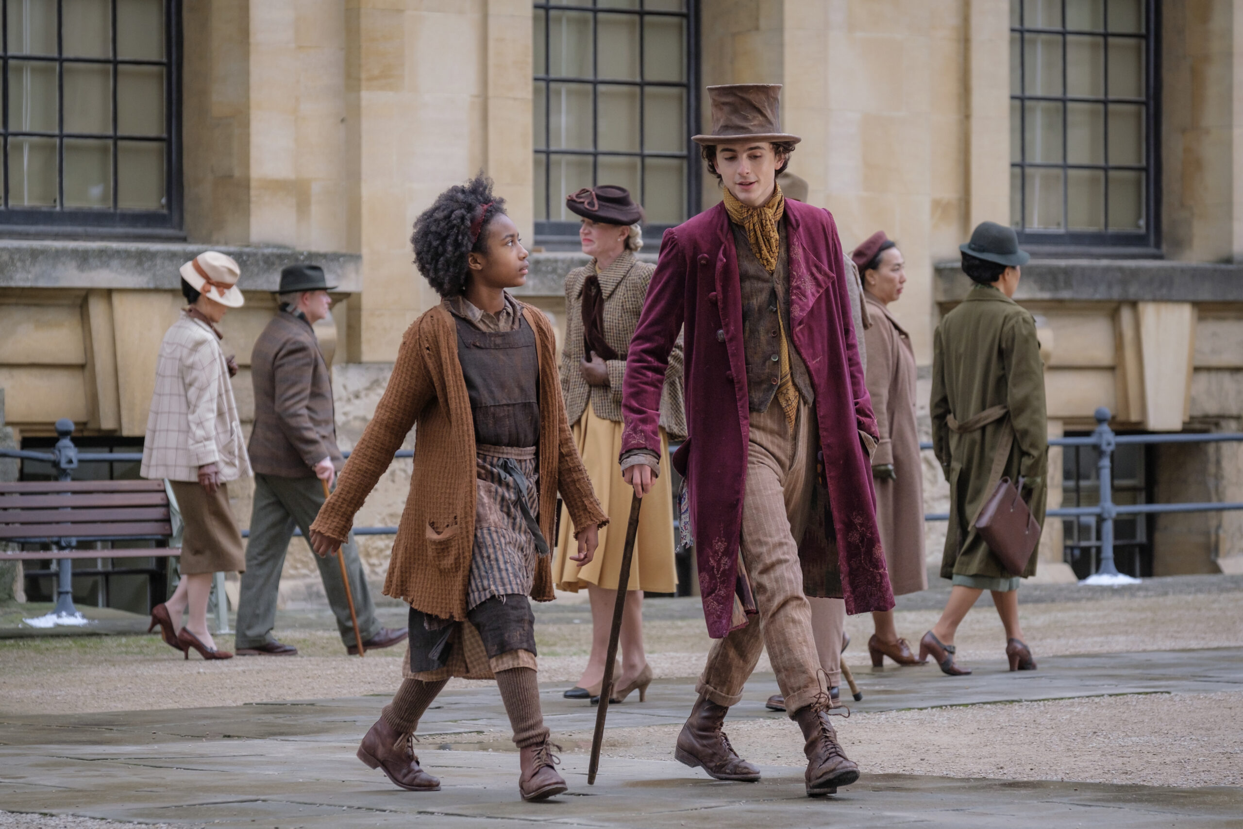 (L to r) Olivia Colman as Mrs Scrubbit and Timothée Chalamet as Willy Wonka in “WONKA” (Photo Credit: Courtesy of Warner Bros. Pictures)