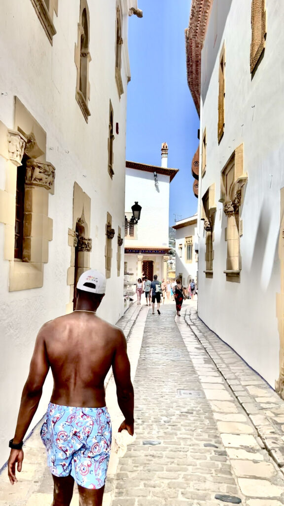 Heney's husband walking down a street in Sitges (Photo Credit: Paul J. Heney)